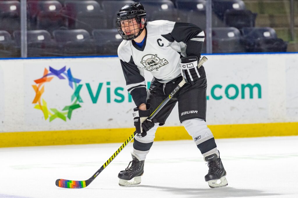 Randy Cote taking the puck up the ice