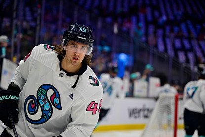Seattle Kraken player skating in a "Kraken Pride Night 2022" jersey.