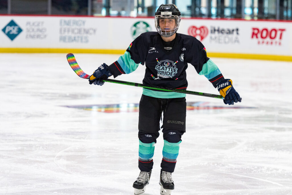 SPHA Vice President, Joey Gale, smiling with a hockey stick on the ice